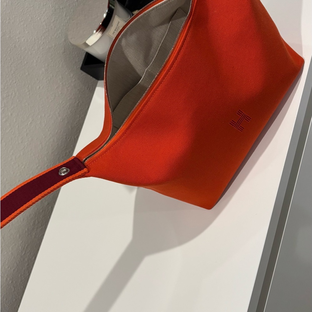 Hermes Orange Travel Bag with Adjustable Strap and Sleek Design
